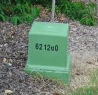 A green service pillar box