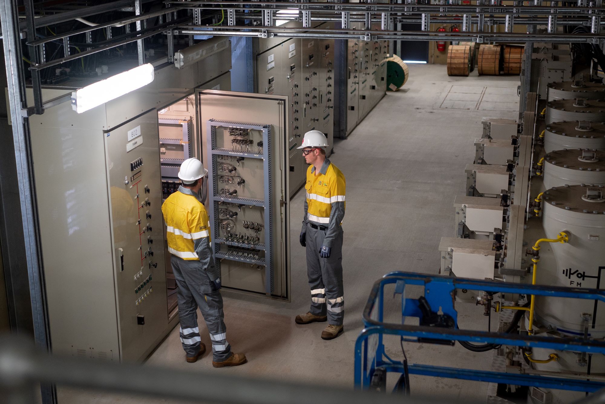 Field crew at open switchboard inside a substation