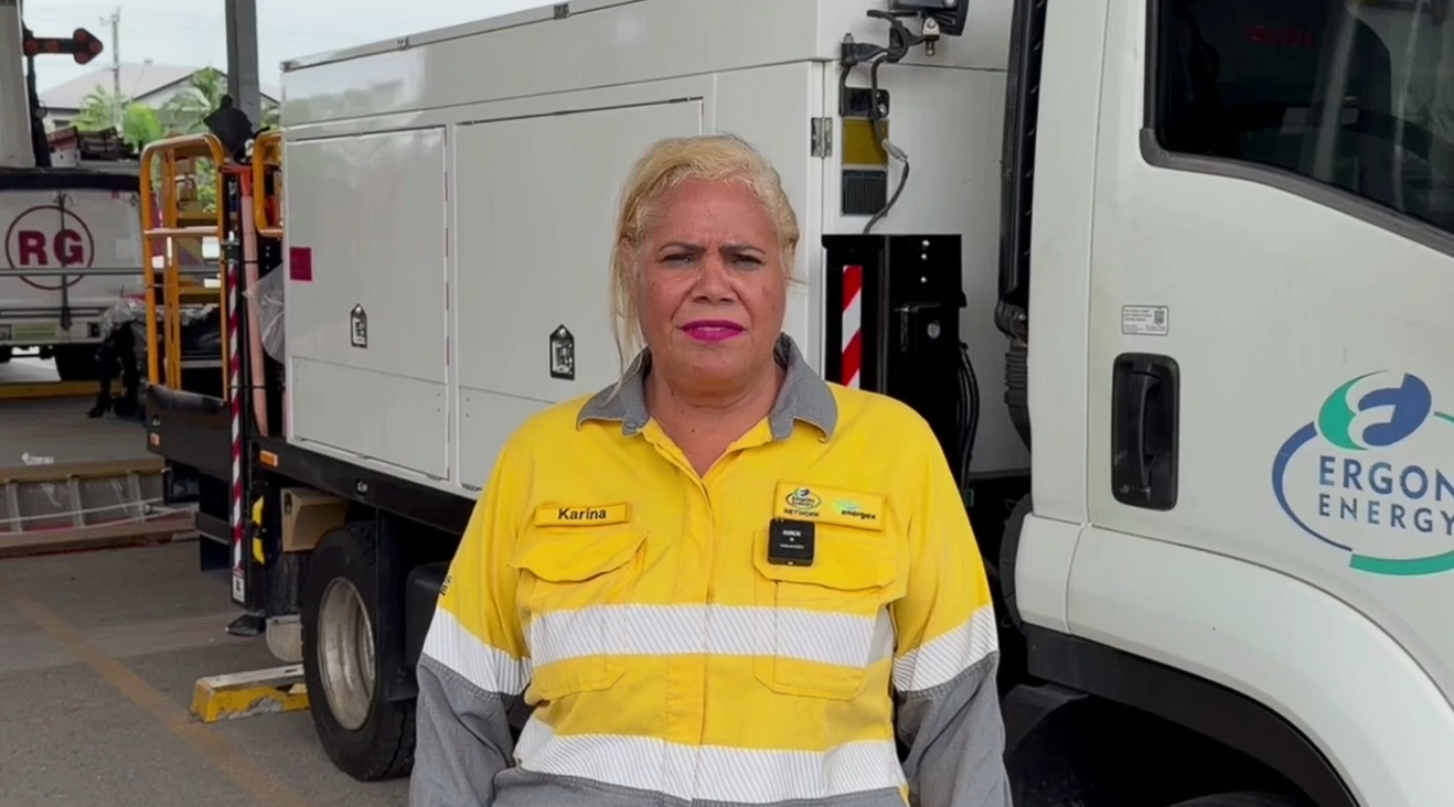 Ergon Energy Network worker standing in front of Ergon Energy vehicle
