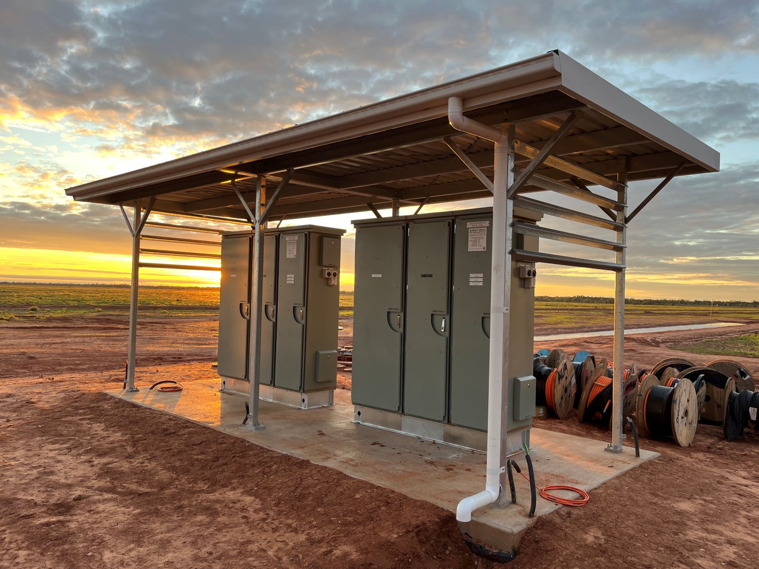 Boulia solar farm inverter switchboards with sunrise in background