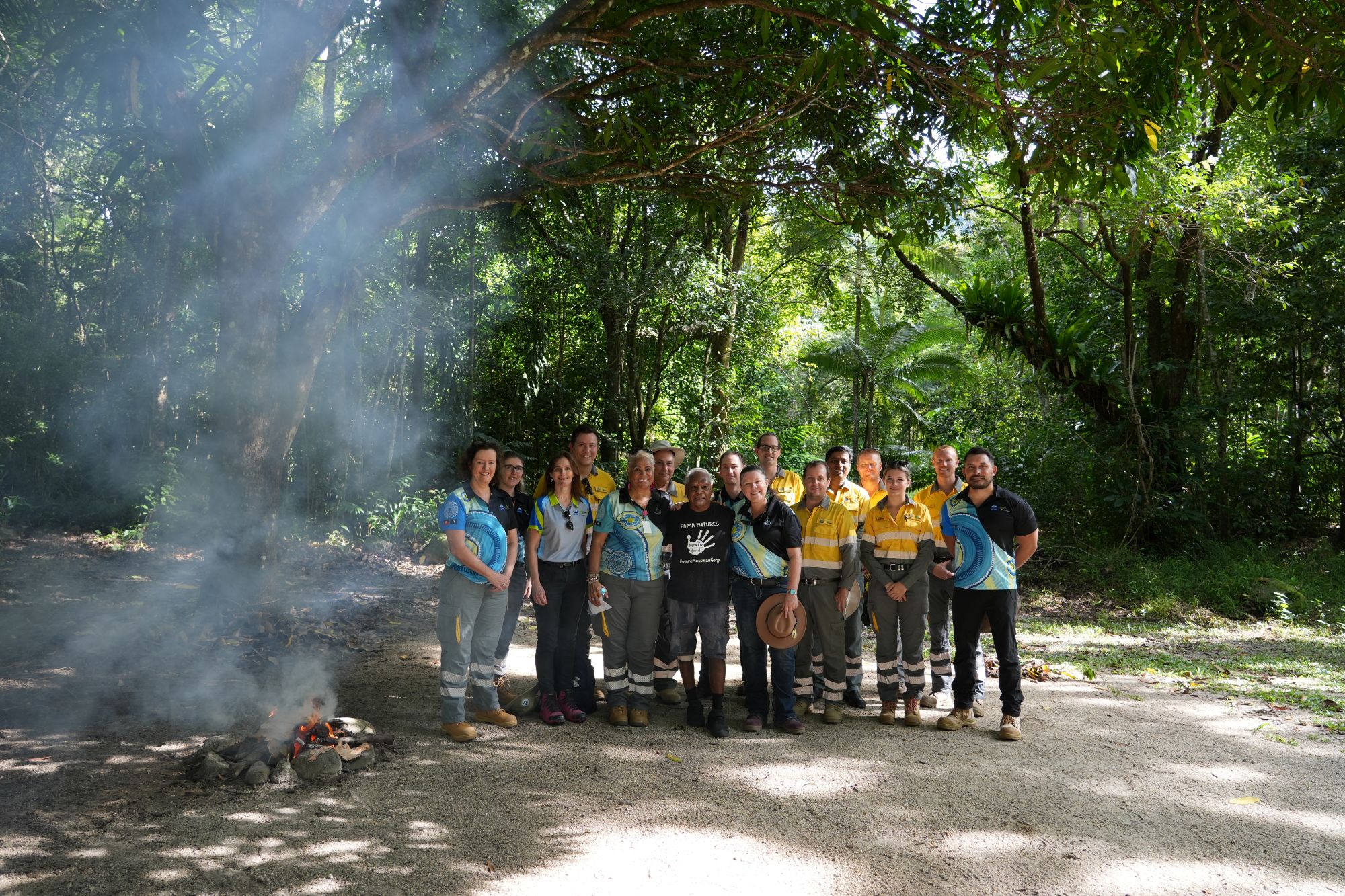 Group of Ergon Energy employees and Uncle Roy Gibson in Kuku Yalanji Country