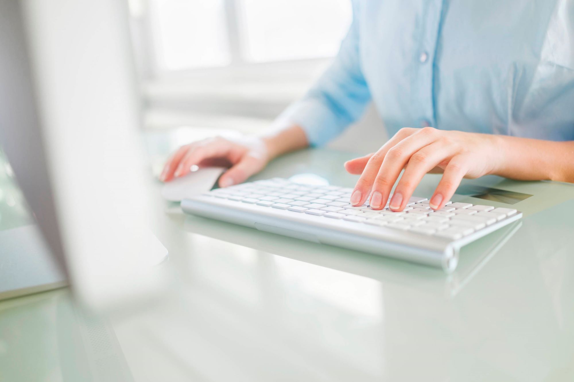 Hand typing on a computer keyboard