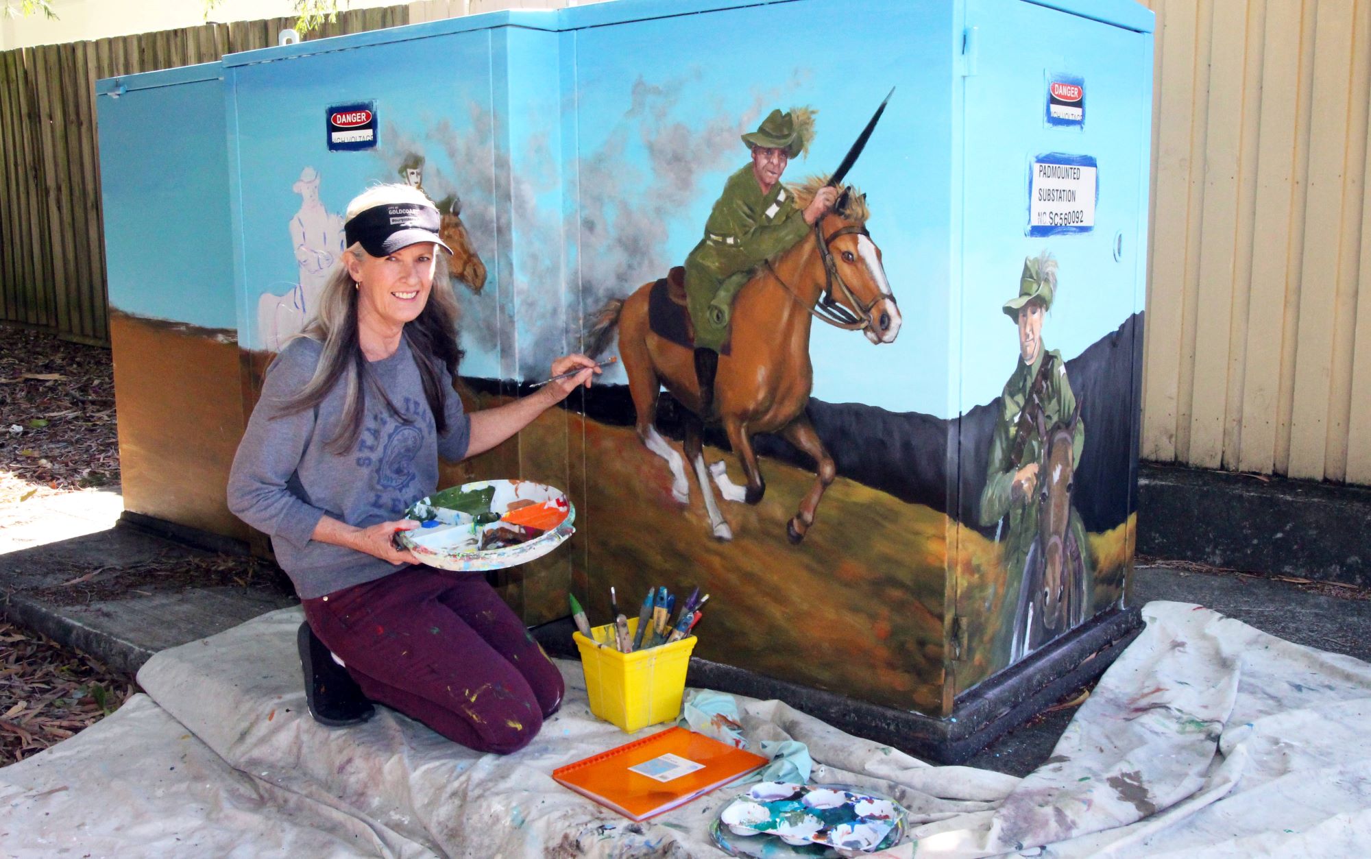 An artist painting an electricity asset
