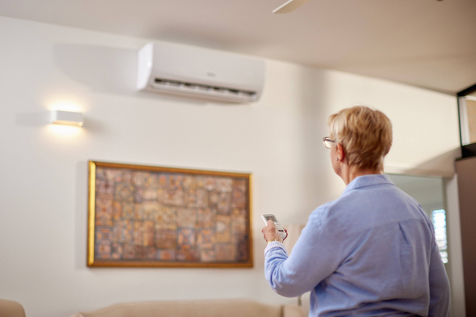 Lady pointing air conditioner remote