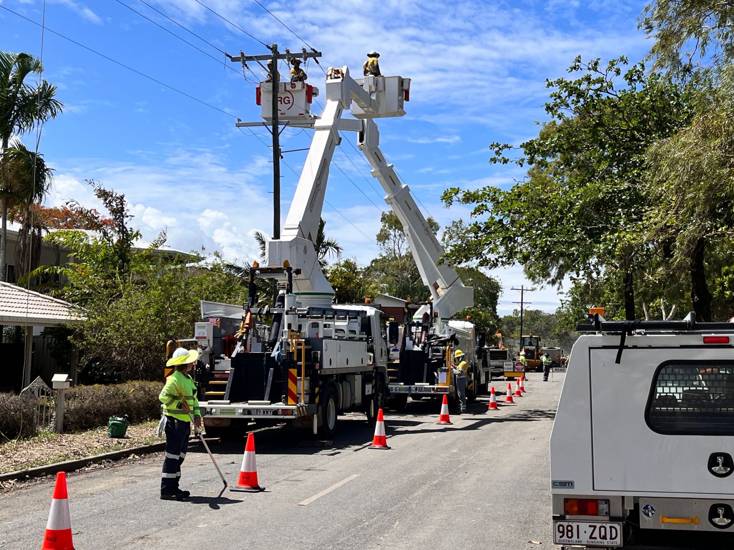 Ergon Energy crews working on a powerlines restoring power at Holloways Beach