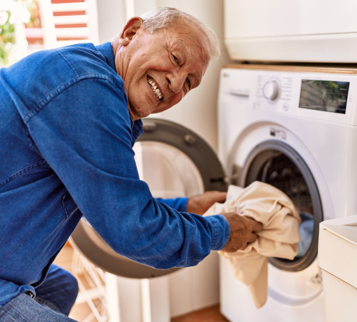 Man doing laundry on a bright, sunny day.