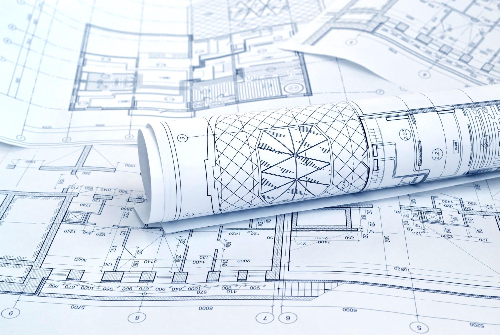 Blueprint plans for property construction on white paper