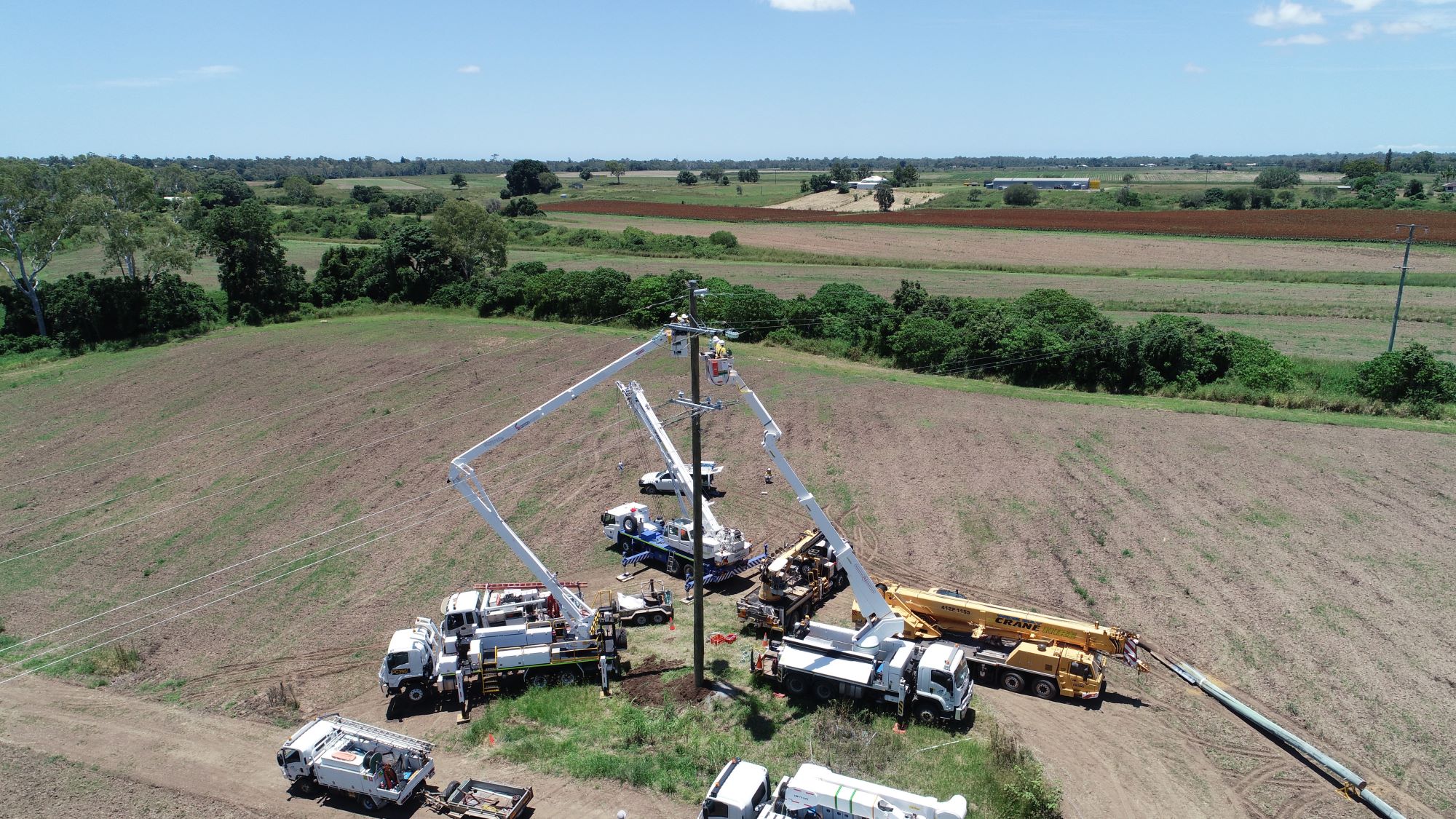 Multiple crews working on powerlines at river crossing.jpg