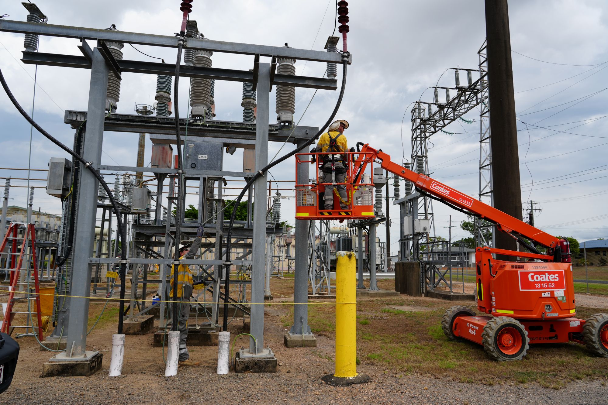 Crew in orange lift working on Ingham substation