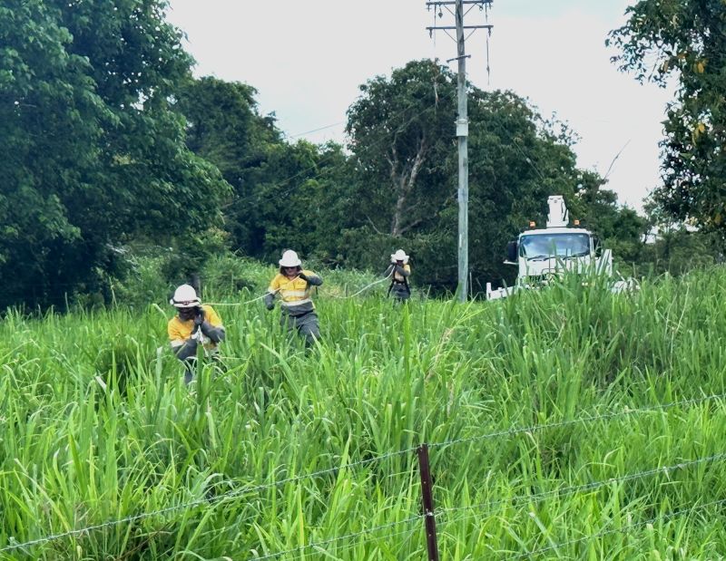 TC Koji crews carrying powerline