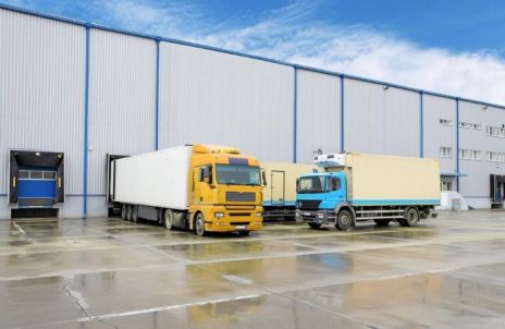 Photo of the outside of a food distribution business and delivery trucks