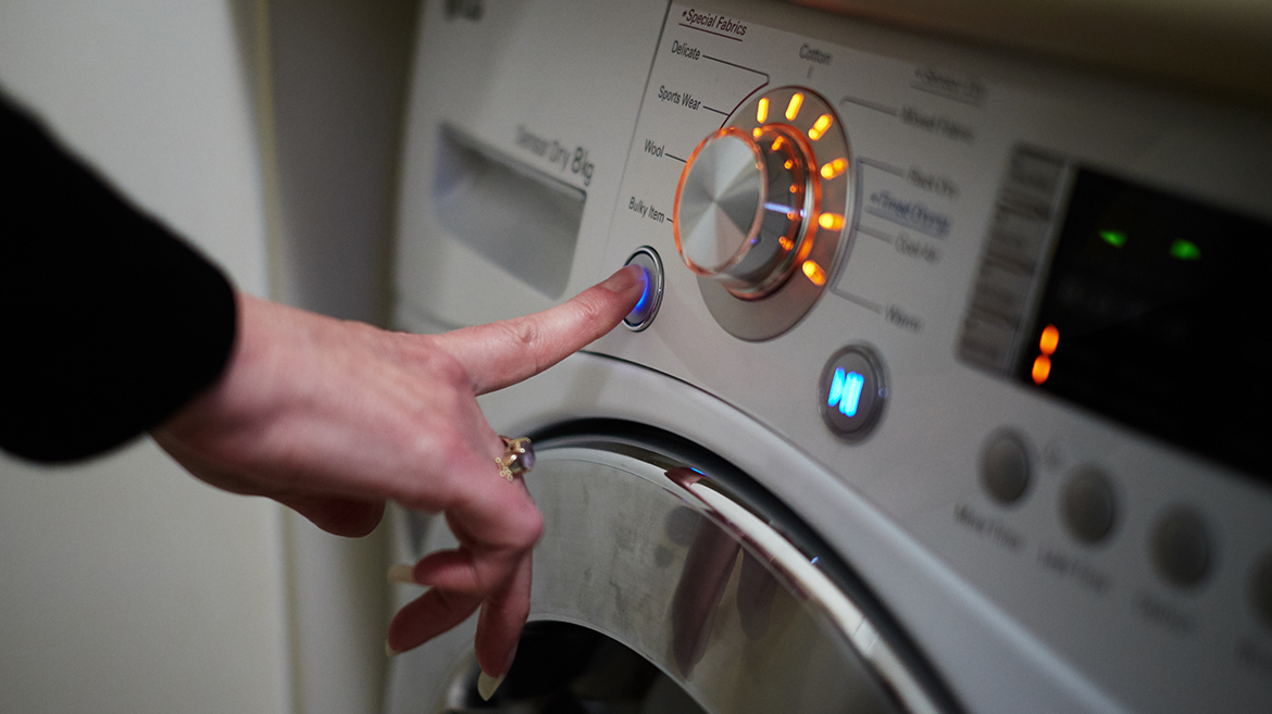 Photo of a washing machine being switched on.