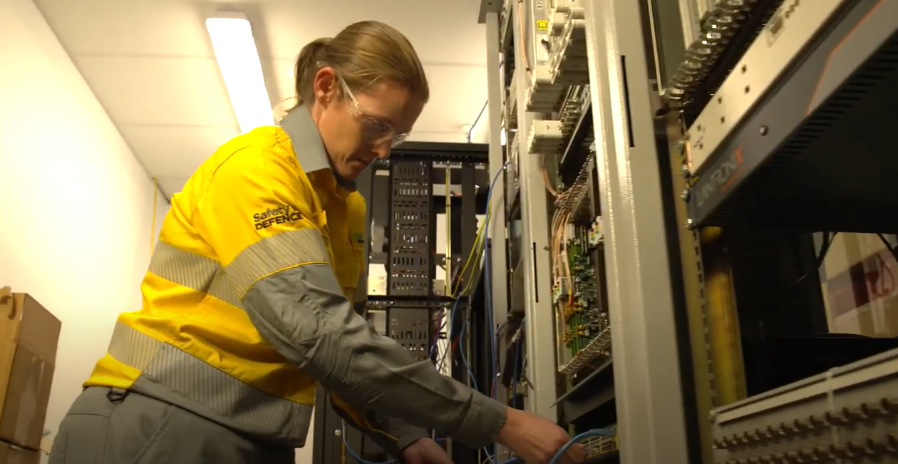 Female crew member working on telcommuncations switchboard