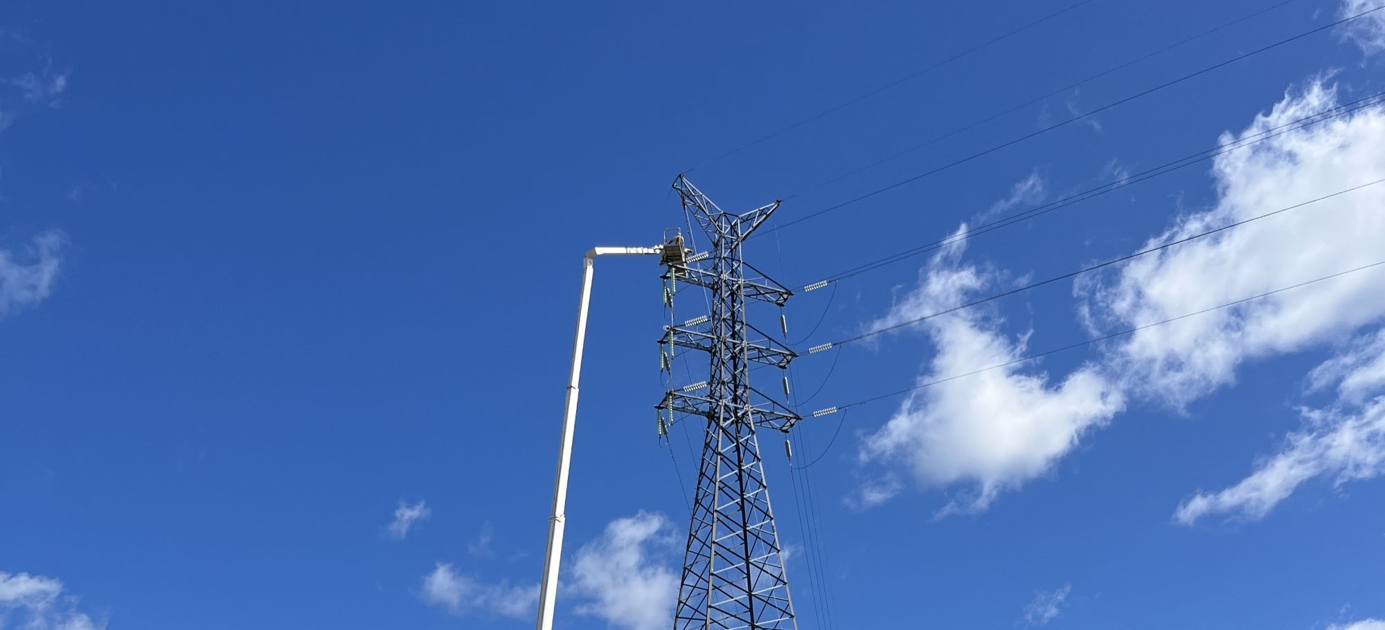 Crews working on powerlines in a field