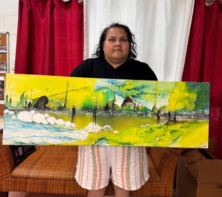 Artist Karen Gibson holding artwork