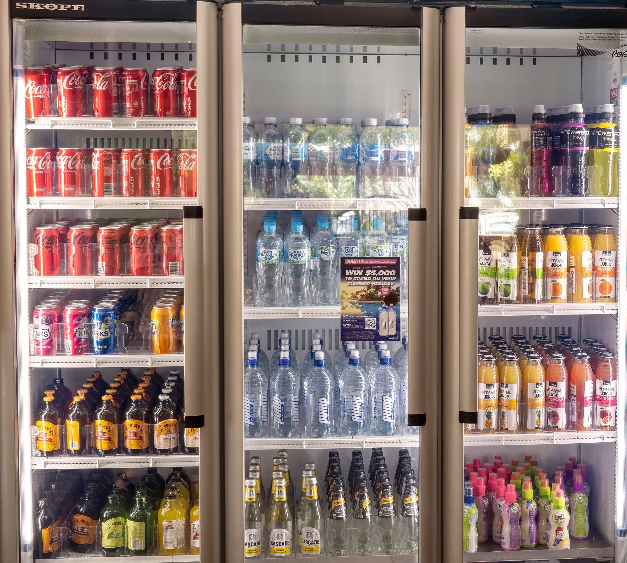 Drinks fridge full of cold liquid refreshments and water