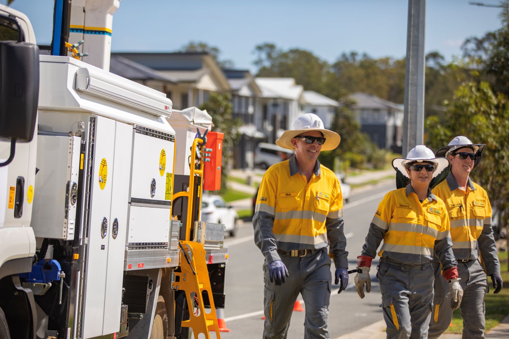 Employees in front of work truck in uniform