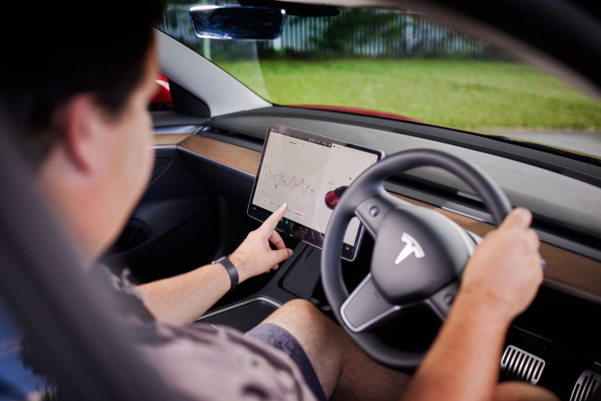 A man sitting behind the wheel of an electric vehicle