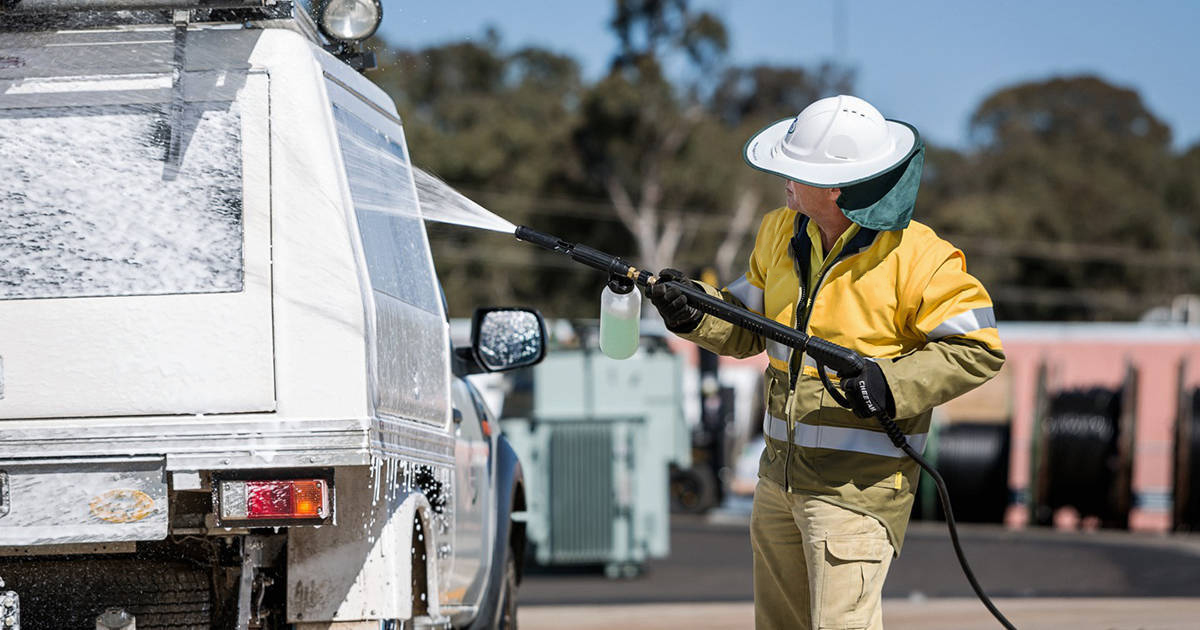 Crew member washing down vehicle for biosecurity reasons 